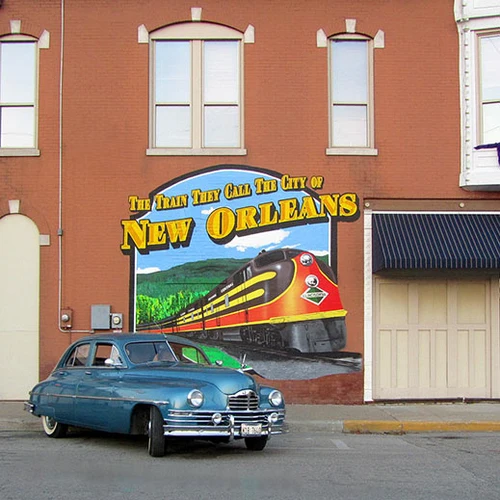 A hand-painted 'City of New Orleans' train mural on a brick building
