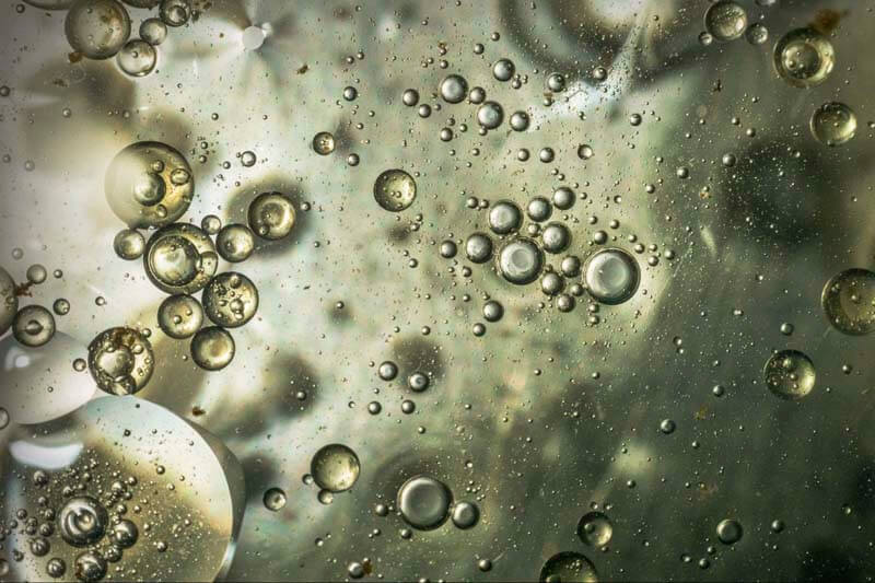 Close-up of water bubbles, representing the technical brewing process Ollie's customers manage daily